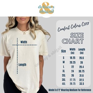 May include: Cream-colored t-shirt with a size chart for Comfort Colors C1717. The chart lists sizes S to 4XL, with width and length measurements in inches. The model is 5'2" and wearing a medium.