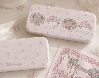 May include: Two rectangular light pink metal cases and a matching rectangular card. The larger case features illustrations of two bears and two rabbits. The smaller case displays the text Girls dream shop. The card shows a bear on a swing.