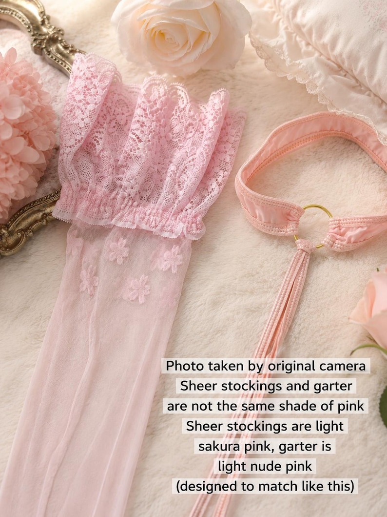 May include: A pair of light sakura pink sheer stockings featuring a floral lace cuff and a light nude pink garter belt with a gold-tone ring connector. The image includes text stating: Photo taken by original camera. Sheer stockings and garter are not the same shade of pink. Sheer stockings are light sakura pink, garter is light nude pink (designed to match like this).