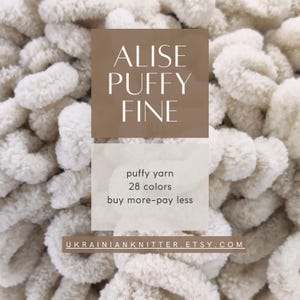 May include: Close-up of ivory-colored Alise Puffy Fine yarn. The image features the text "puffy yarn 28 colors buy more-pay less" and the Etsy shop URL. The yarn appears soft and chunky, ideal for various crafting projects.