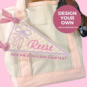 May include: A canvas tote bag with a pink and cream color scheme. A personalized, quilted pennant with a ballet theme is attached. The pennant features a bow, ballet shoes, and the name "Reese". Text on the pennant says "Pick the icon & add your text".