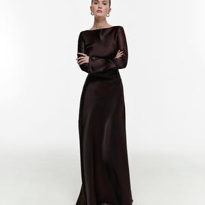 Elegant chocolate cocktail dress with long sleeves, a floor-length design, and a hidden back zipper. Ideal for formal events, weddings, or evening occasions. Made from thick, non-transparent fabric that ensures a flattering fit and refined sophistication.