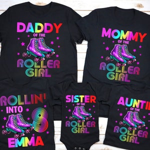 May include: A set of five black t-shirts with rainbow text and roller skate graphics. The shirts say "Daddy of the Roller Girl", "Mommy of the Roller Girl", "Rollin' into 8 Emma", "Sister of the Roller Girl", and "Auntie of the Roller Girl".