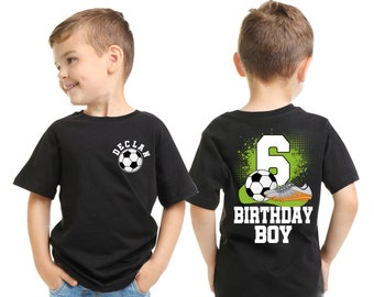 May include: Two black t-shirts with a soccer theme. One shirt has a soccer ball with the name "Declan" on it. The other shirt has a soccer ball, a soccer cleat, and the number "6" with the text "Birthday Boy".