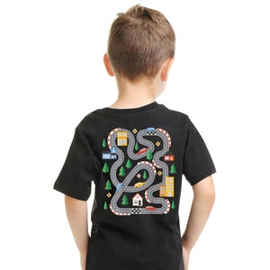 May include: Black t-shirt with a colorful graphic of a winding road with houses, trees, and cars.