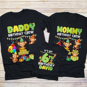 May include: Black t-shirts with the text "Daddy Birthday Crew" and "Mommy Birthday Crew" featuring monkeys and presents. A smaller black t-shirt says "It's my 6th Birthday David" with a monkey and presents.