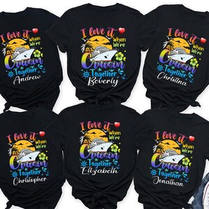 May include: Black t-shirts with a colorful graphic design featuring a cruise ship, palm trees, and the text "I love it when we're cruisin' together" with a name below. The names are Andrew, Beverly, Christina, Christopher, Elizabeth, and Jonathan.