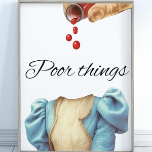May include: Framed art print featuring a watercolor illustration. The image shows a hand pouring red liquid from a vial, with drops falling towards a blue and beige dress. The words "Poor things" are written in cursive.