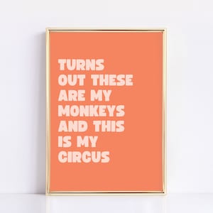 May include: A peach-colored framed print with the text "TURNS OUT THESE ARE MY MONKEYS AND THIS IS MY CIRCUS" in white.