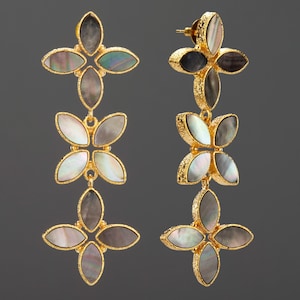 May include: A pair of long drop earrings featuring three stacked floral-shaped segments. Each segment is composed of four marquise-cut iridescent mother-of-pearl inlays set in textured gold-tone metal frames with a post-back closure mechanism.