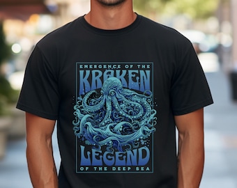 May include: A black t-shirt with a blue graphic of a kraken, a mythical sea monster, emerging from the waves. The text "Emergence of the Kraken Legend of the Deep Sea" is printed on the shirt.