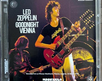 May include: A CD case for Led Zeppelin's "Goodnight Vienna" album. The image shows a live concert with a musician playing a double-neck red guitar. Text includes "Led Zeppelin," "Goodnight Vienna," and "Moonchild Records."