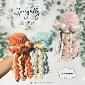 May include: Three crocheted jellyfish plushies in orange, blue, and pink variegated yarn. The text reads Sprightly Jellyfish and PDF Pattern. Each jellyfish features a rounded head and long, curly tentacles in cream and matching variegated colors.