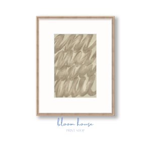 May include: A framed print with a beige abstract pattern of overlapping lines and swirls. The frame is a light wood color. The print is titled "bloom house" with the words "PRINT SHOP" below.