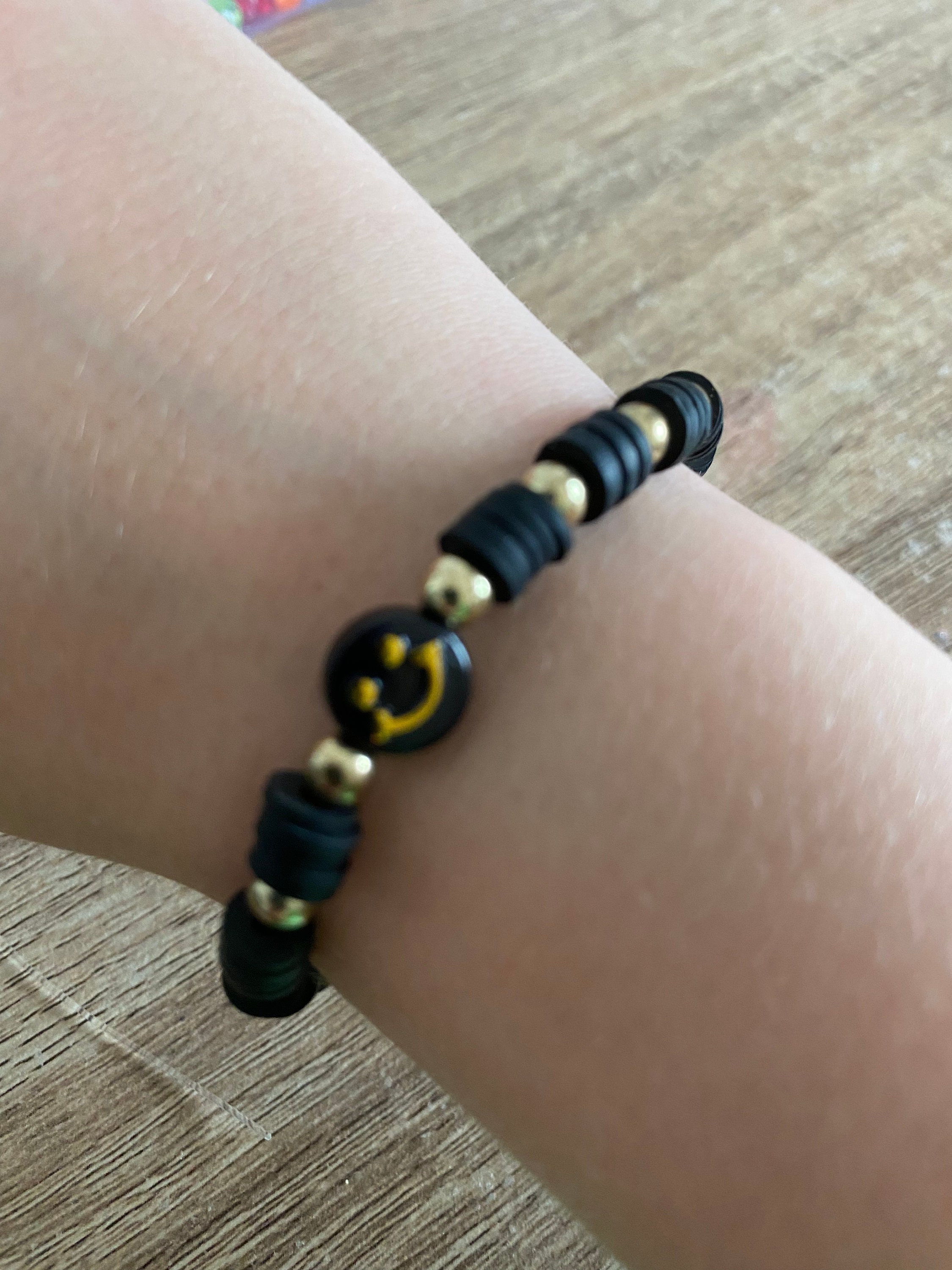 Black Clay Beaded Bracelet with Black and Gold Happy Face Charm