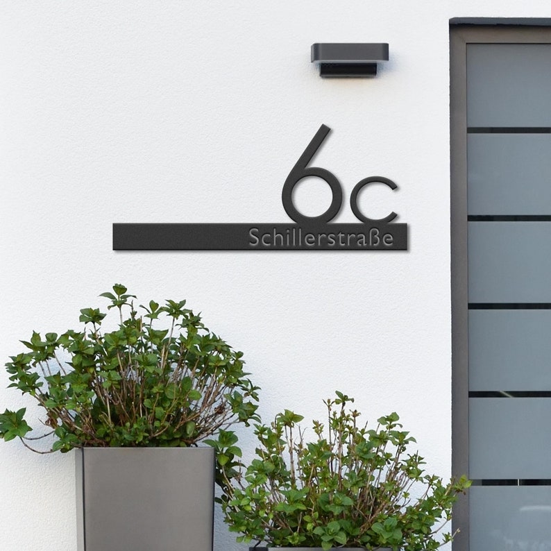 May include: Black metal house number sign with the number 6c and the street name Schillerstra&szlig;e.