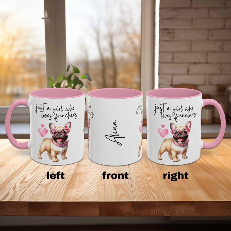 May include: A white ceramic mug with a pink rim and handle. The mug has a design of a French bulldog wearing pink glasses and the text "just a girl who loves frenchies". The mug also has the name "Alina" written on the front.