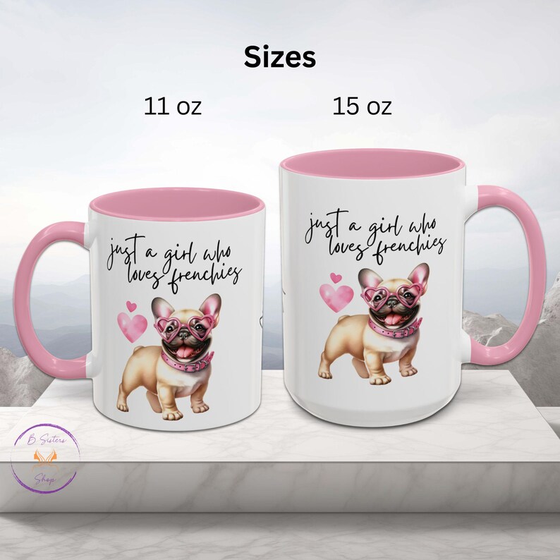 May include: Two white ceramic mugs with pink rims. The 11 ounce mug and the 15 ounce mug both feature a pink-rimmed design and a graphic of a French bulldog wearing pink heart-shaped glasses. The text on the mug reads "Just a girl who loves frenchies".
