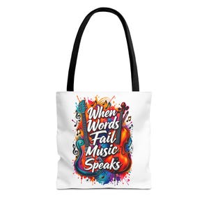 Puede incluir: Un bolso tote blanco con asas negras que presenta un gráfico colorido de una guitarra eléctrica azul y un violonchelo marrón. El diseño incluye notas musicales y el texto When Words Fail Music Speaks en blanco sobre un fondo de salpicaduras.