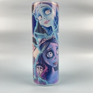 May include: A white stainless steel tumbler with a colorful graphic print of characters from the movie "The Corpse Bride".