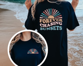 May include: Black t-shirt with a graphic of a sunset and the text "FOREVER CHASING SUNSETS" on the back. The front of the shirt has a smaller graphic of a sunset.