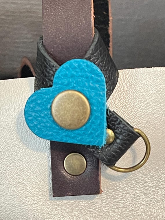 Flair holder to safely attach charms to PLG Portland Leather Goods bags. Made with pebble black and Baja full grain leather. Bronze hardware