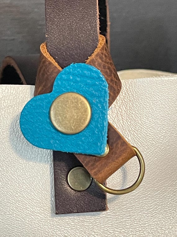 Flair holder to safely attach charms to PLG Portland Leather Goods bags. Made with brown and Baja full grain leather. Bronze hardware