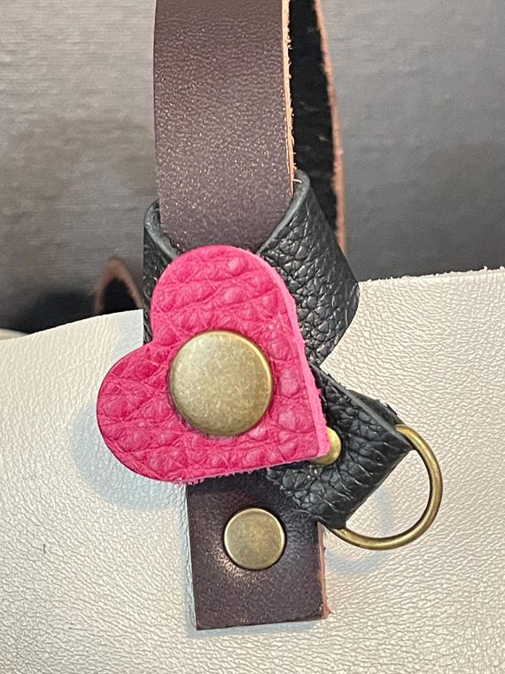 Flair holder to safely attach charms to PLG Portland Leather Goods bags heart. Made with pebble black full grain leather. Bronze hardware