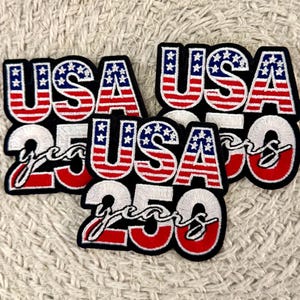 May include: Three embroidered patches featuring the text USA in a red, white, and blue flag pattern, with the number 250 in white below it and the word years in white cursive script. Each patch has a black border and a thick, textured stitch finish.