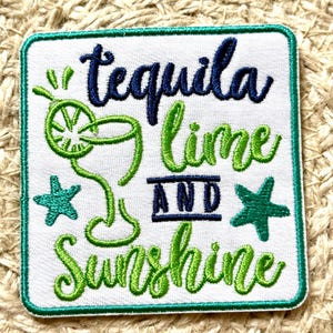 May include: Square white embroidered patch with the words "tequila lime and sunshine" in green and navy blue script. A green cocktail glass and two green starfish are also embroidered on the patch. The patch has a green border.