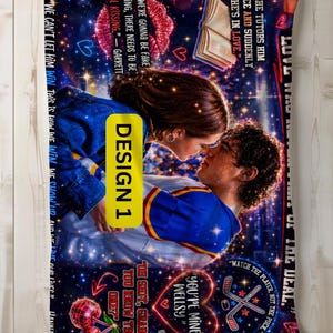 May include: A blanket featuring a romantic scene of a couple kissing, set against a starry night backdrop. The design includes text excerpts and graphics like hearts, hockey sticks, and cherries. The blanket has a yellow "DESIGN 1" label.