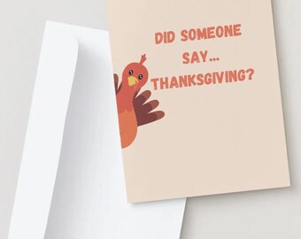 May include: A greeting card featuring a cartoon turkey peeking out from the bottom left corner. The card has a peach background and the text "Did someone say... Thanksgiving?" in orange.