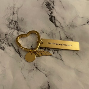 can I be young forever? Nessa Barrett Keychain (Gold with Angel Wing)