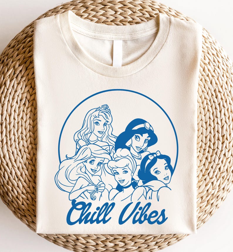 Minimalist blue line art of Disney princesses with "Chill Vibes" text on cream t-shirt; features Ariel, Cinderella, Snow White, Belle, and Jasmine in a relaxed, modern design.
