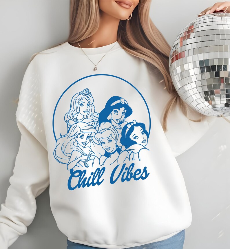 Minimalist blue line art of Disney princesses with "Chill Vibes" text on cream t-shirt; features Ariel, Cinderella, Snow White, Belle, and Jasmine in a relaxed, modern design.