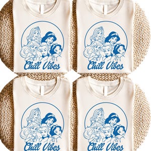 Minimalist blue line art of Disney princesses with "Chill Vibes" text on cream t-shirt; features Ariel, Cinderella, Snow White, Belle, and Jasmine in a relaxed, modern design.