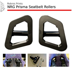May include: Black NRG Prisma Seatbelt Rollers. The image shows two black seatbelt rollers with a unique geometric design. The product name and brand, "Robros Prints" are displayed at the top. Additional images show the rollers installed and disassembled.