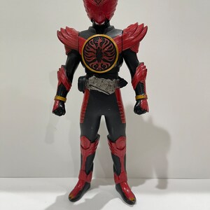 May include: A red and black action figure of a superhero with a bird-like helmet and a circular emblem on its chest.