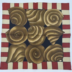 May include: A black silk scarf with a red and cream striped border. The center of the scarf features a pattern of brown seashells.