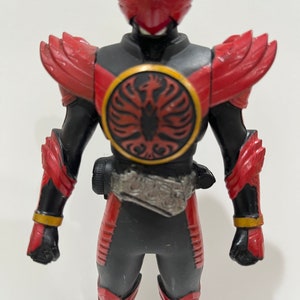 May include: A red and black action figure of a superhero with a red helmet and a black and gold belt. The figure has a red and gold symbol on its chest.