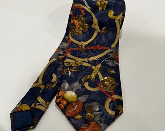 May include: A dark blue silk tie with a colorful floral pattern. The pattern features red, yellow, orange, and green flowers and leaves on a navy blue background.