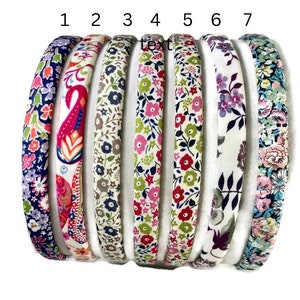 May include: Seven colorful fabric headbands with floral patterns. The headbands are arranged in a row from left to right, numbered 1 through 7.