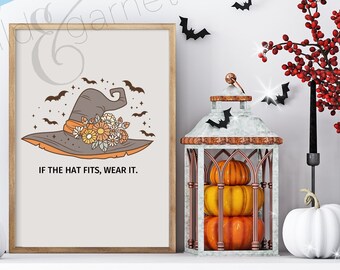 May include: A printable Halloween-themed digital download featuring a witch's hat with flowers and the text "If the hat fits, wear it."