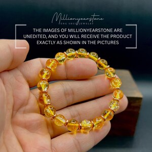 May include: A bracelet featuring golden-yellow, translucent gemstone beads with copper-coloured spacers. The image text states that the images are unedited and the product will be exactly as shown.