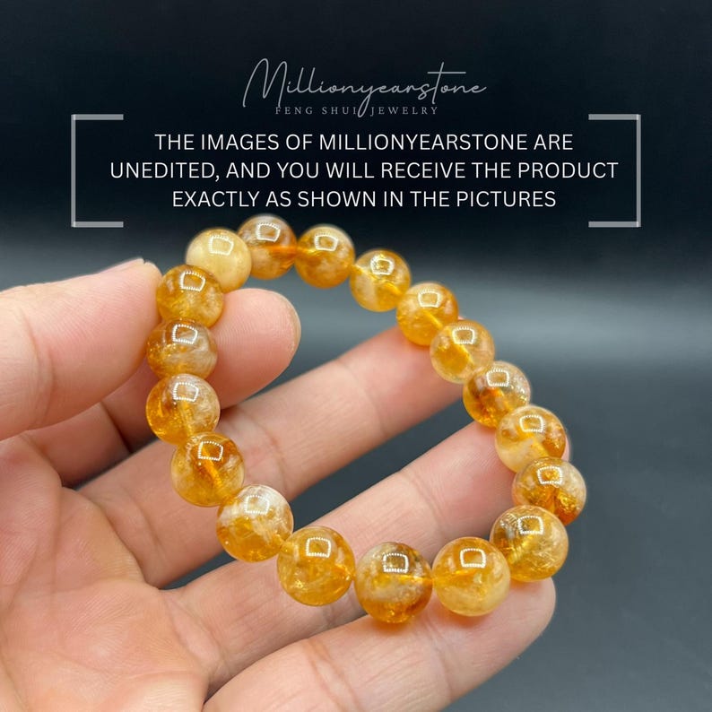 May include: A bracelet made of golden-yellow citrine gemstone beads. The beads are round and have a translucent quality. The bracelet is held in a hand against a dark background. Text in the image states the product is unedited.