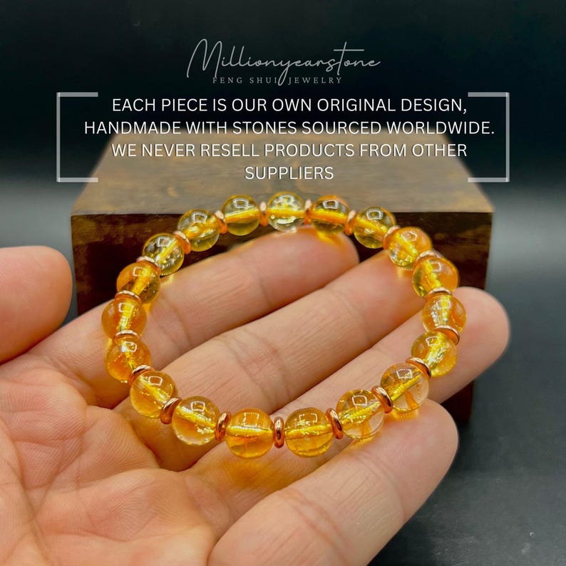 May include: A bracelet featuring golden yellow beads and rose gold spacers. The round, translucent beads are strung together. The image includes the text: "Each piece is our own original design, handmade with stones sourced worldwide. We never resell products from other suppliers."