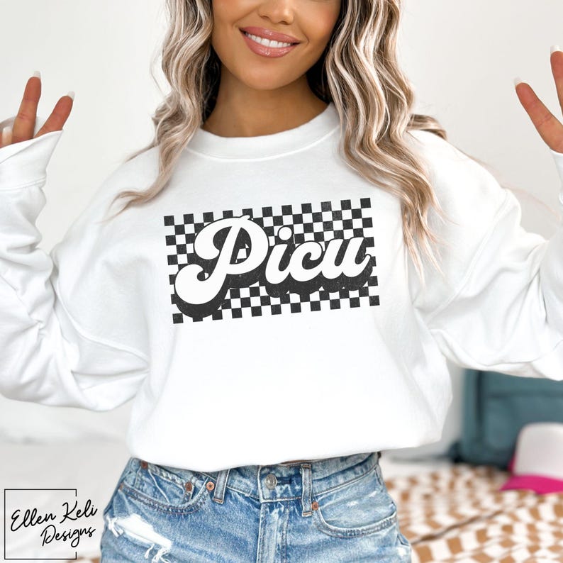 May include: White sweatshirt with a black and white checkered design and the word "PICU" in a retro font.