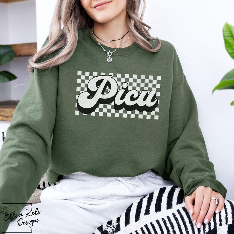 May include: A green sweatshirt with a white checkered pattern and the word "Picu" in a retro font.