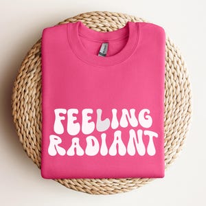 a pink t - shirt that says feeling radiant on it