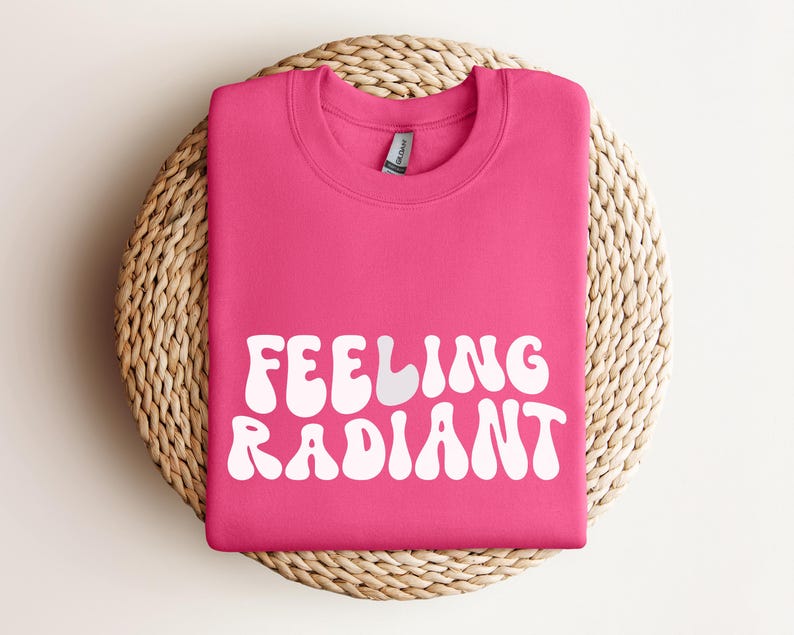 a pink t - shirt that says feeling radiant on it